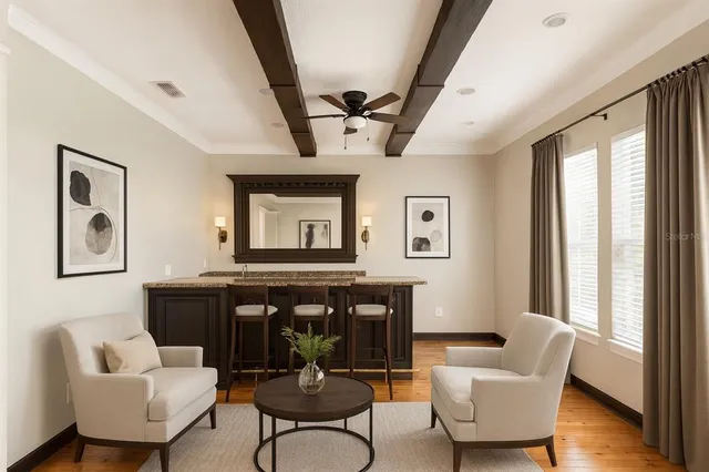 a living room with furniture and wooden floor