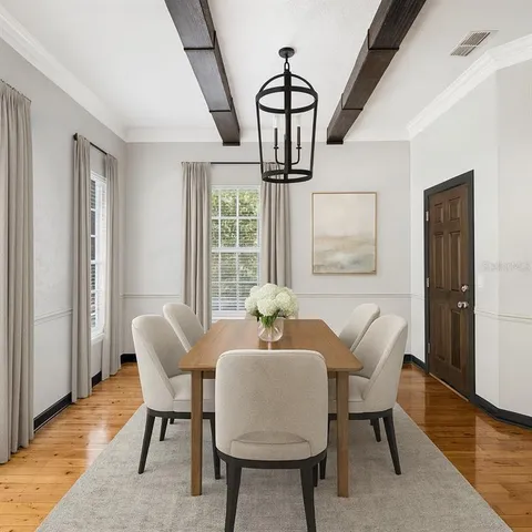 a dining room with furniture and wooden floor