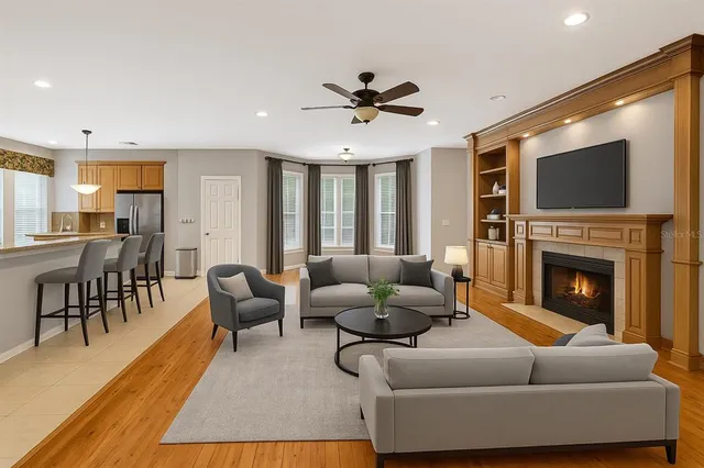 a living room with furniture a fireplace and a flat screen tv