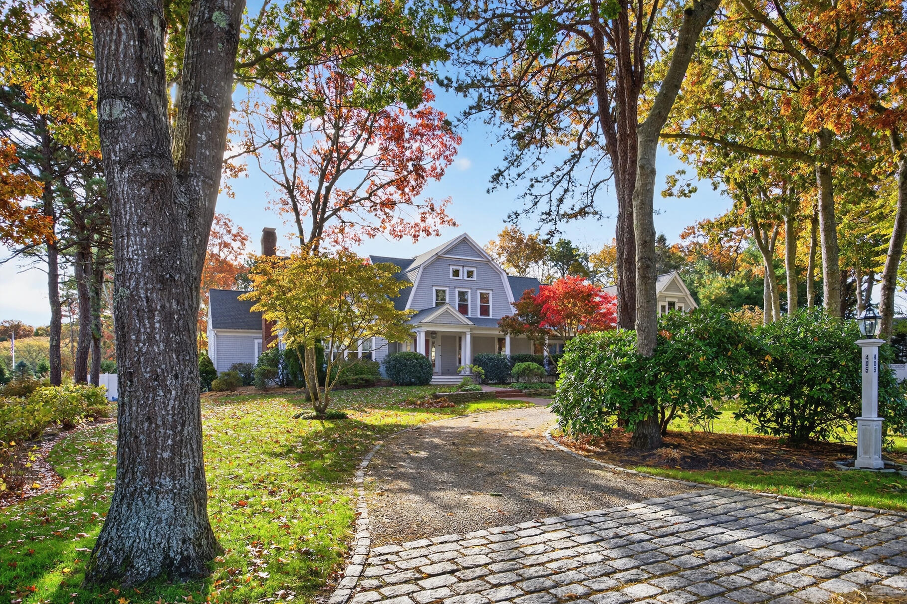 405 Bridge Street Osterville, MA 02655 - Photo 3 of 57 a front view of a house with a yard and large trees