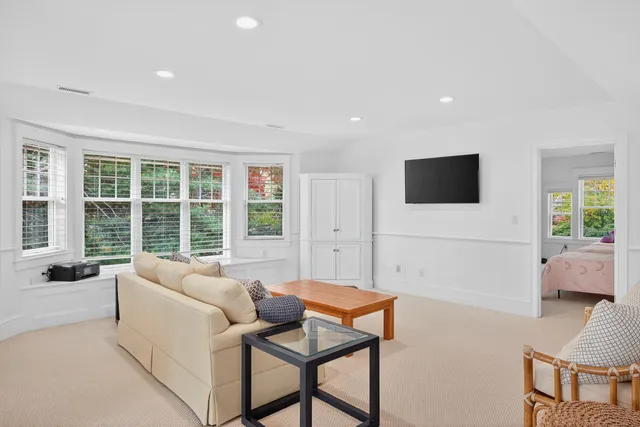 a blue and white sitting area with furniture