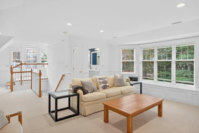 a living room with furniture and large windows
