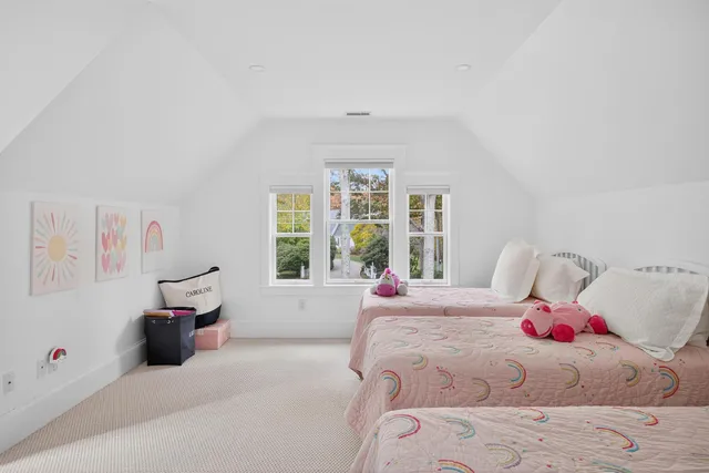 a front view of a house with a garden and swimming pool