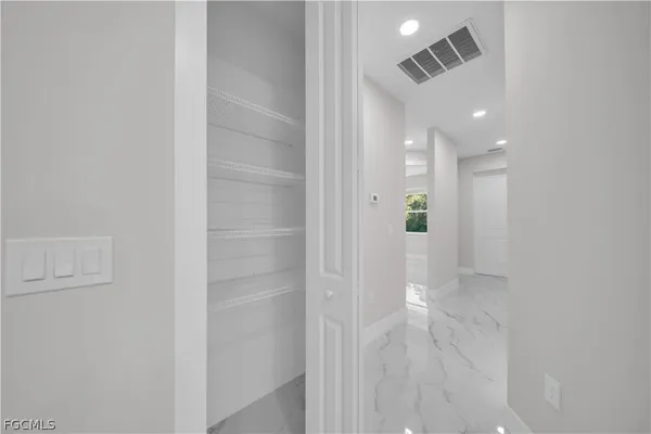 a kitchen with stainless steel appliances a sink dishwasher and white cabinets with wooden floor