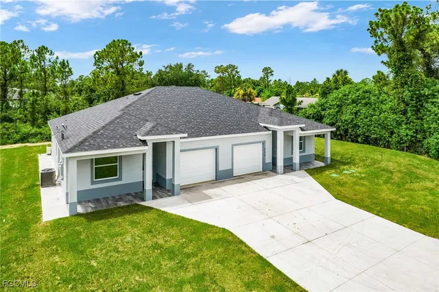 an aerial view of residential house with outdoor space and trees all around
