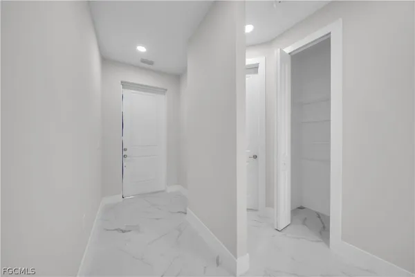 an empty room with a window and a ceiling fan