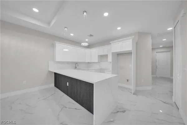 an empty room with fan and windows