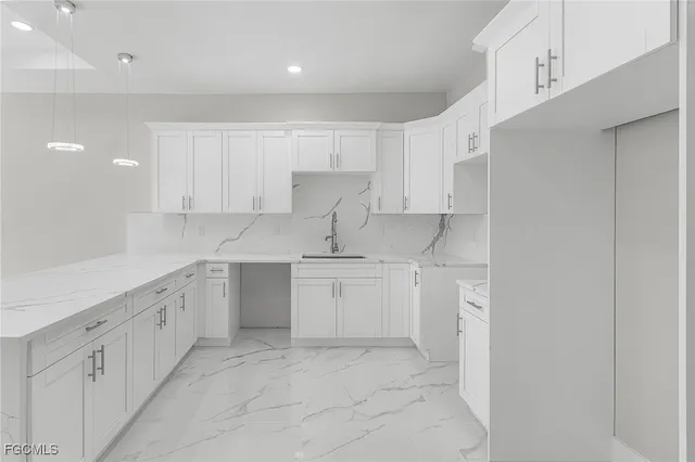 a kitchen with white cabinets
