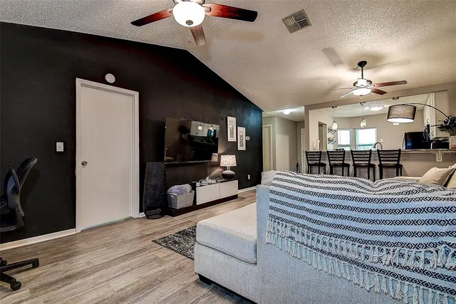 a view of a livingroom with furniture and a flat screen tv
