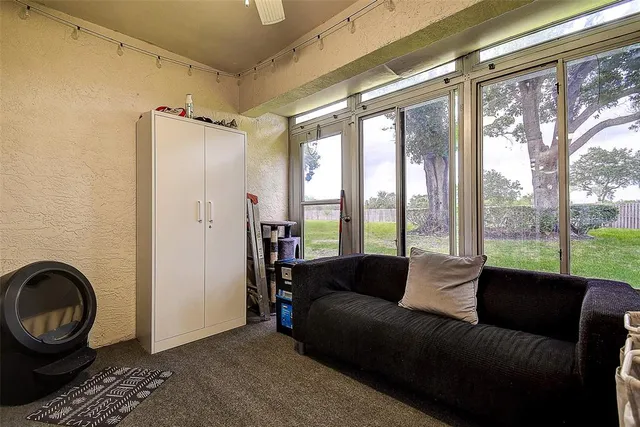 a living room with furniture and a floor to ceiling window