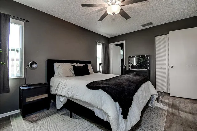 a bedroom with a large bed and a chandelier