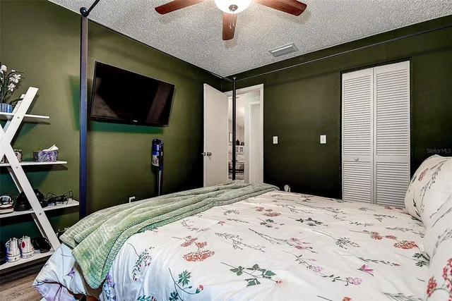 a bedroom with a bed and a flat screen tv