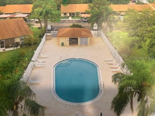 an aerial view of a house with swimming pool and garden