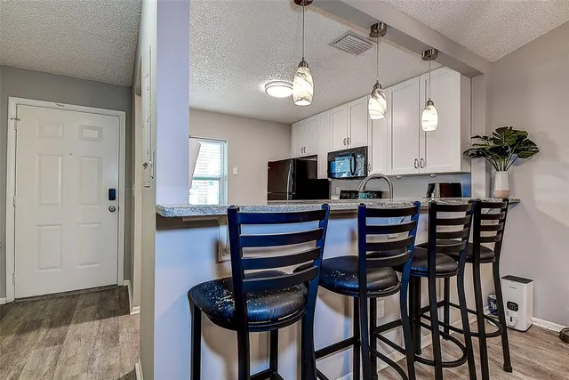 a view of a dining room with furniture and a chandelier