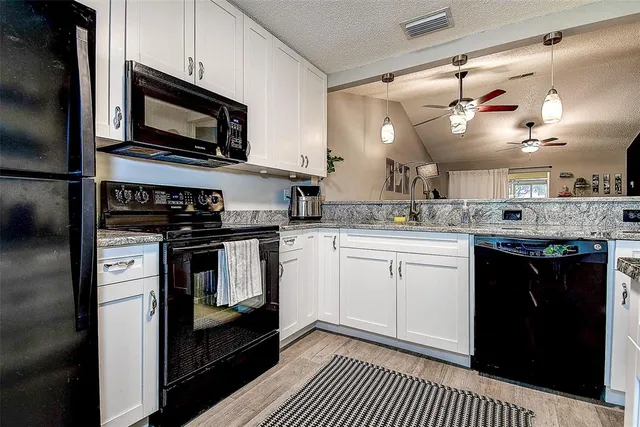a kitchen with a sink stove and microwave