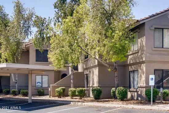 a front view of a building with tree s