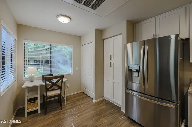 a metallic refrigerator freezer sitting in a kitchen
