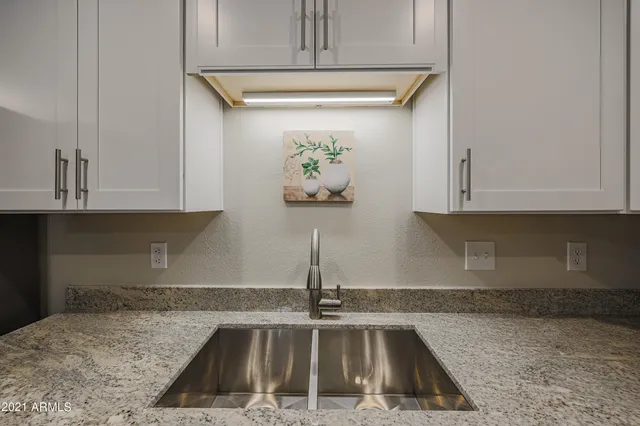 a kitchen with a sink and cabinets