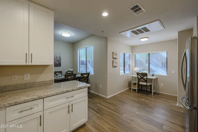a kitchen with sink cabinets and wooden floor