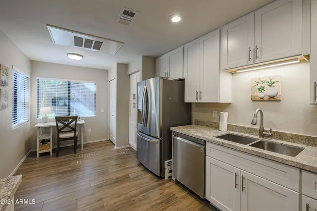 a kitchen that has a sink cabinets counter space and appliances