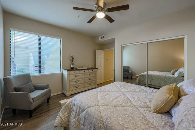 a bedroom with a bed and ceiling fan
