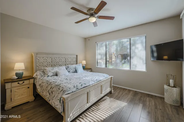a bedroom with a bed and a flat screen tv