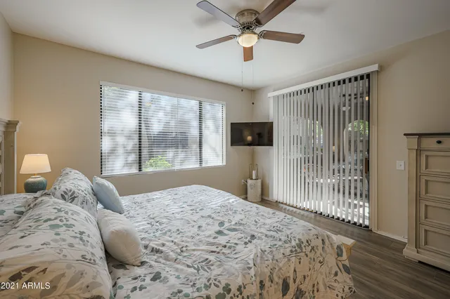 a bedroom with a large bed and a tv