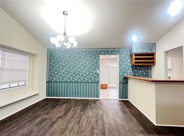 a view of kitchen with furniture and wooden floor