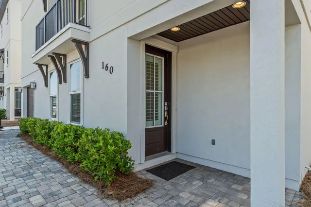 a bedroom with a bed a chandelier and a chair