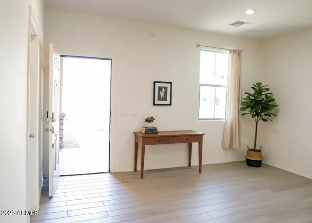 a view of room with a potted plant and wooden floor