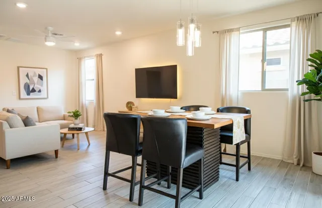 a view of a dining room with furniture window and wooden floor