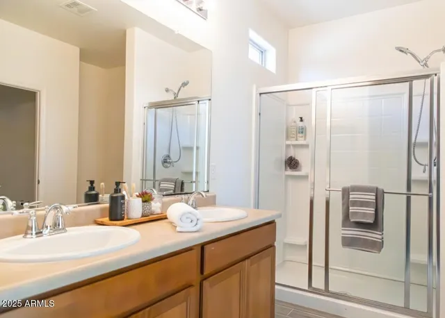 a bathroom with a double vanity sink mirror and double