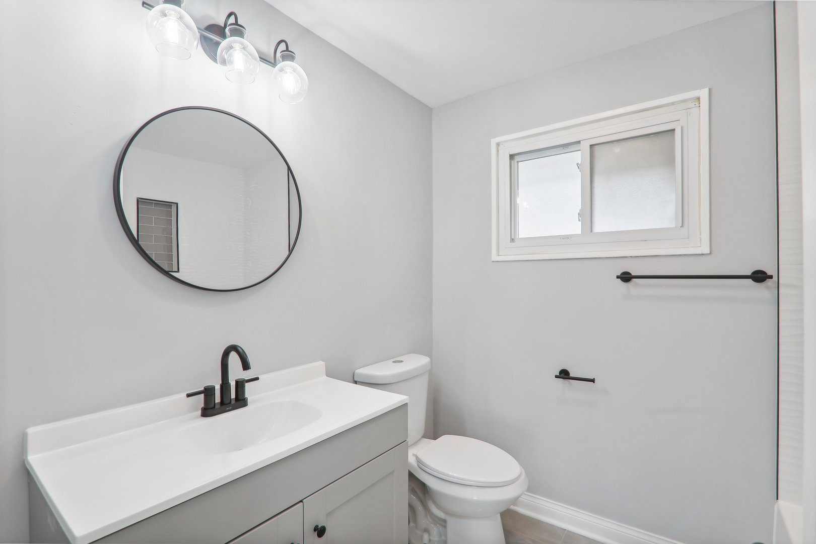 3120 173rd Street Hazel Crest, IL 60429 - Photo 16 of 24 a bathroom with a sink a toilet and a mirror
