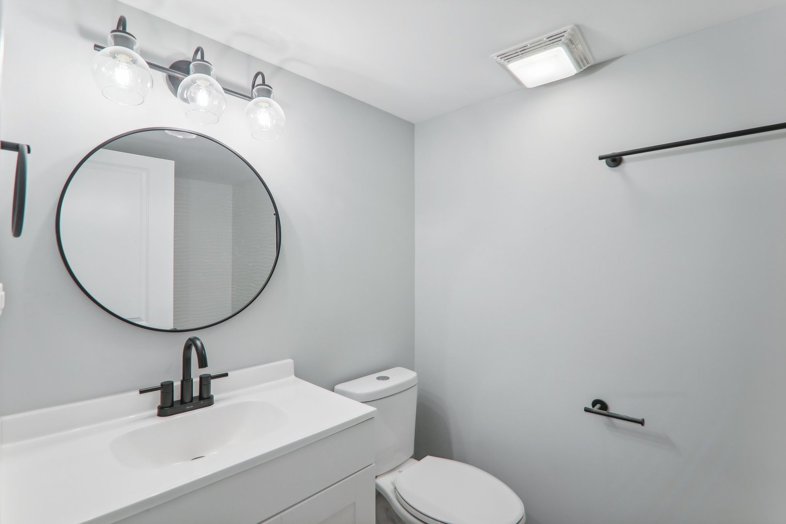 3120 173rd Street Hazel Crest, IL 60429 - Photo 22 of 24 a bathroom with a sink mirror and toilet