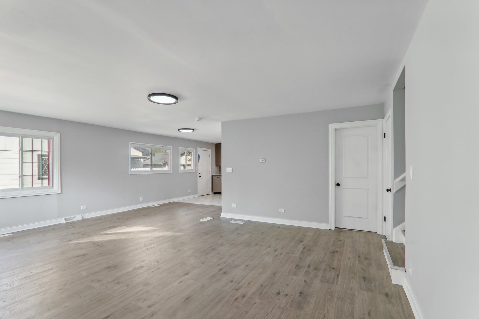 3120 173rd Street Hazel Crest, IL 60429 - Photo 4 of 24 a view of an empty room with a window and wooden floor