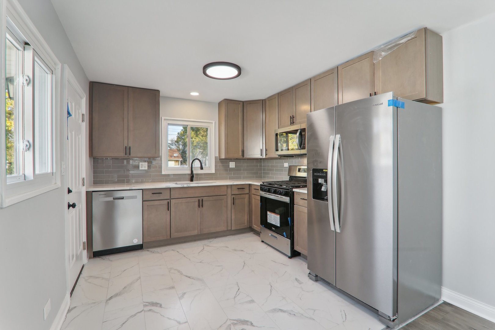 3120 173rd Street Hazel Crest, IL 60429 - Photo 8 of 24 a kitchen with a refrigerator sink and cabinets