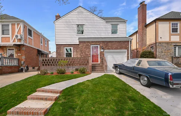 a view of a house with a yard and sitting area