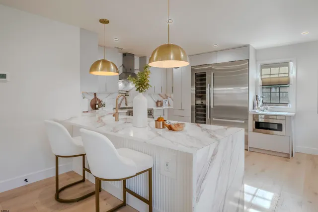 a kitchen with sink cabinets and dining table