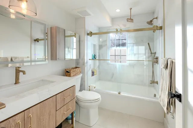 a white toilet sitting next to a bathroom sink