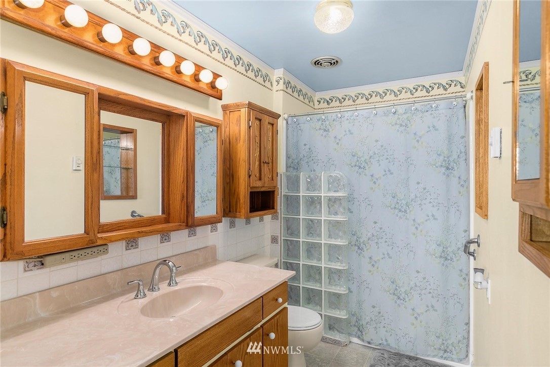 1617 Ludwig Road Snohomish, WA 98290 - Photo 15 of 31 a bathroom with a sink mirror and a shower