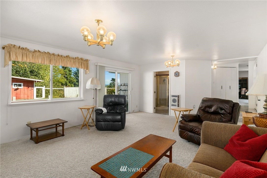 1617 Ludwig Road Snohomish, WA 98290 - Photo 6 of 31 a living room with furniture a chandelier and a window