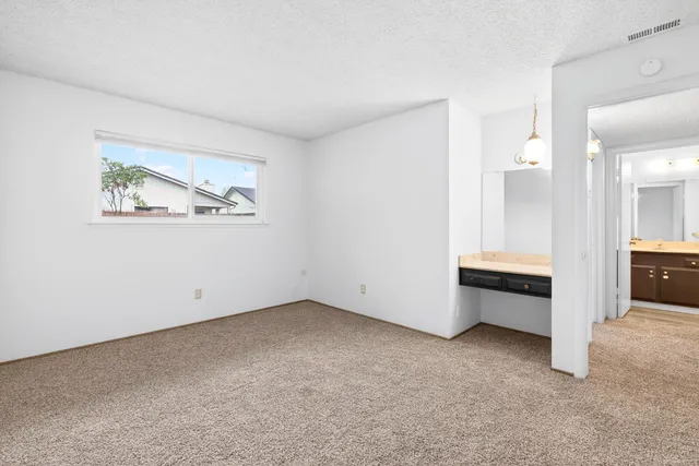 a view of a hallway with a sink and a refrigerator