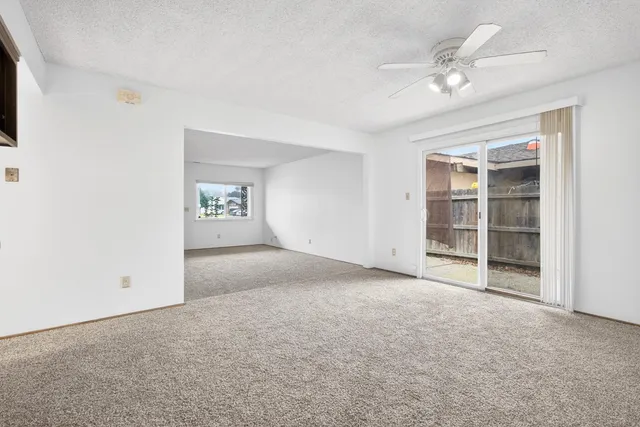 a view of a backyard with wooden fence