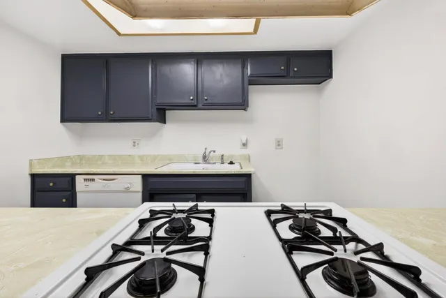 a kitchen with wooden cabinets and a stove top oven