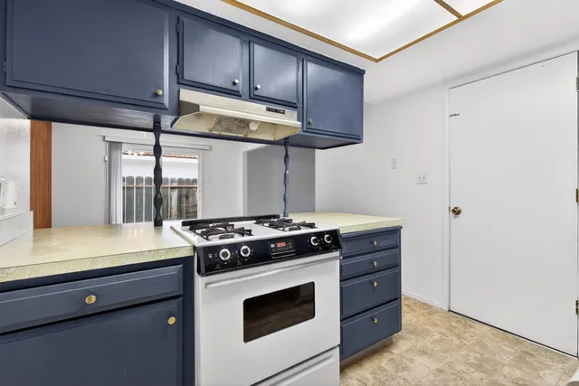a kitchen with a sink cabinets and wooden floor