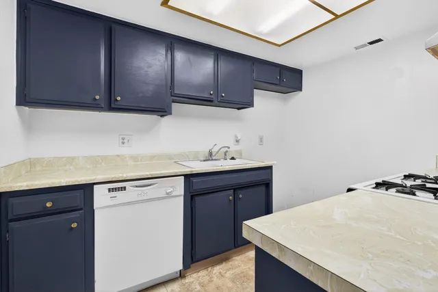 a kitchen with stainless steel appliances granite countertop a stove and a sink