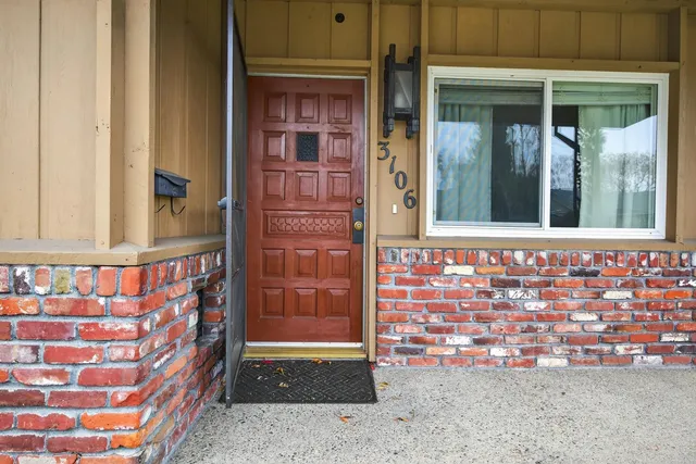 an empty room with a window and closet