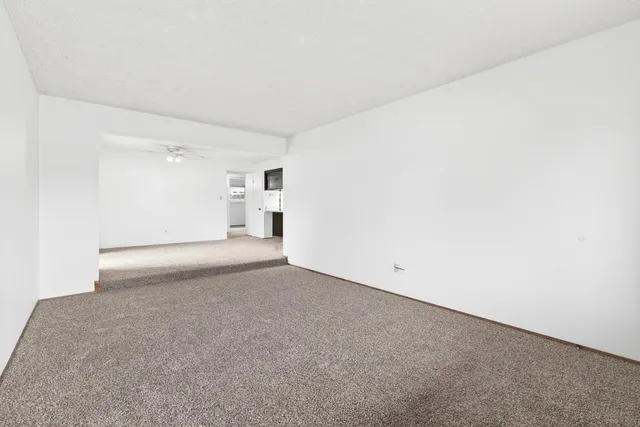 a view of kitchen with a sink and a refrigerator