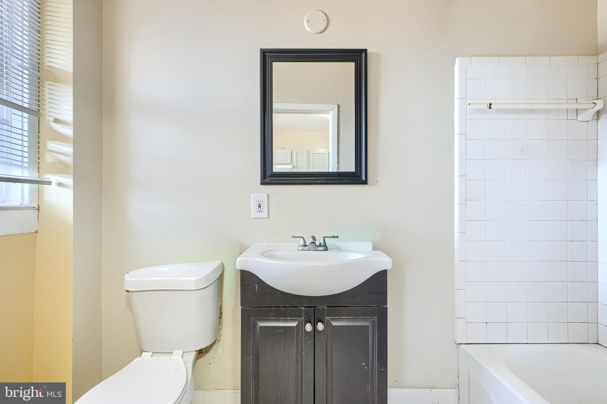 3218 Belair Road Baltimore, MD 21213 - Photo 15 of 26 a bathroom with a sink and a toilet