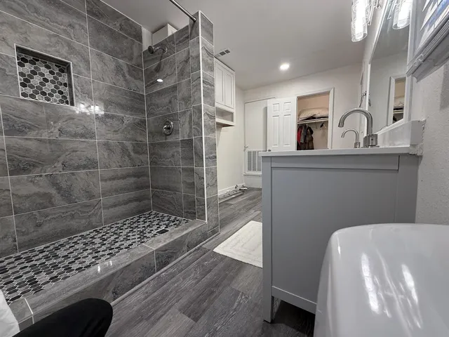 a bedroom with a bed and a ceiling fan